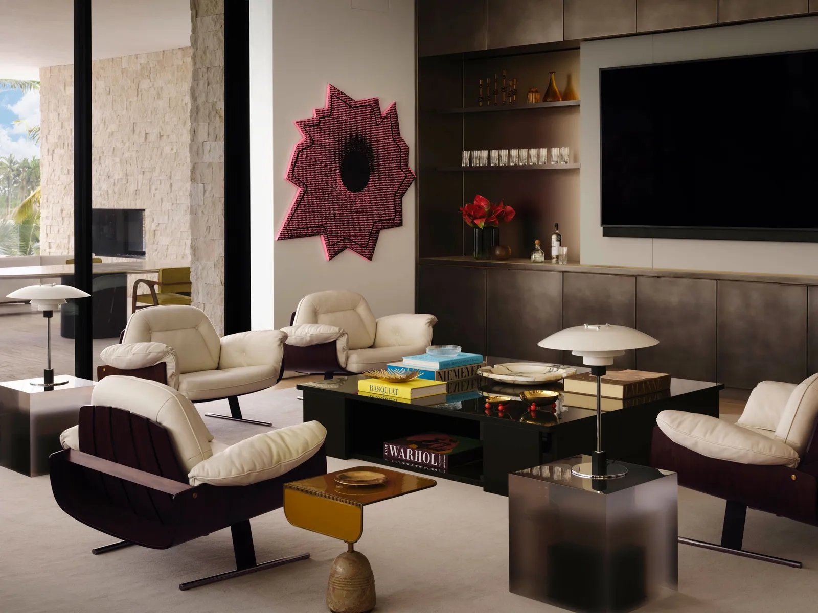 Designer lounge with cream chairs, art wall, and dark cabinetry